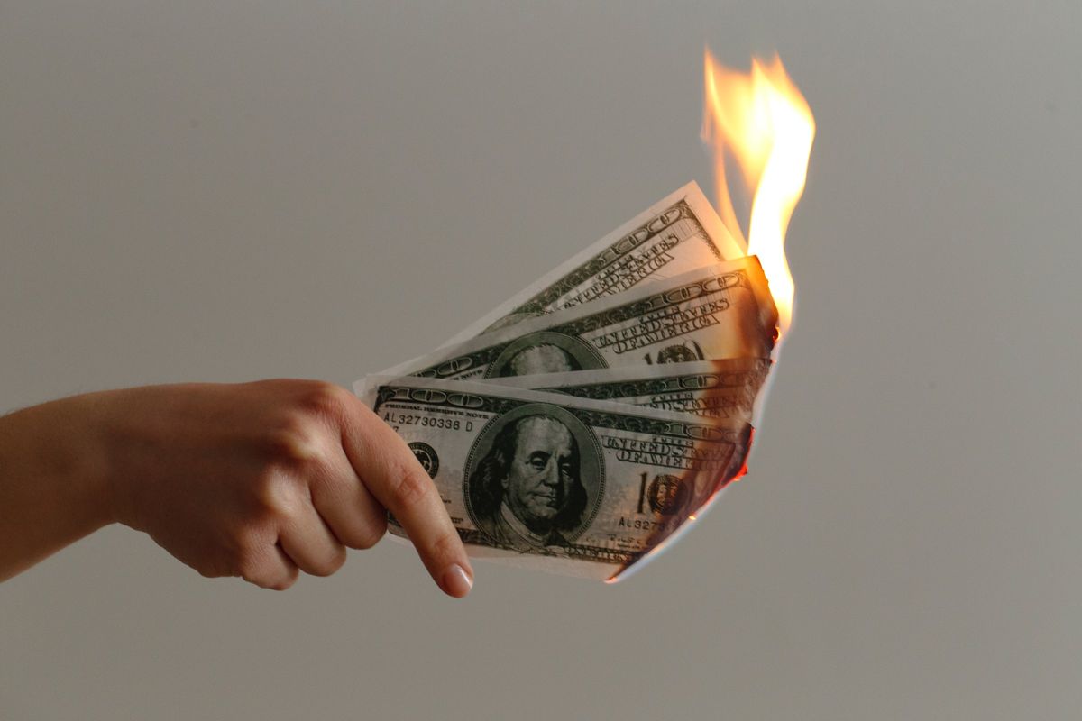 4 burning $100 bills.